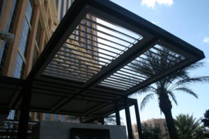 A louvered patio in front of an apartment complex by Apollo