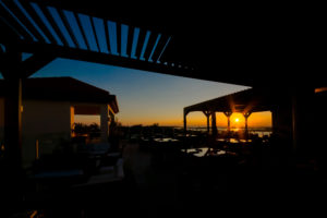 An image of a louvered roof for restaurants at sunset