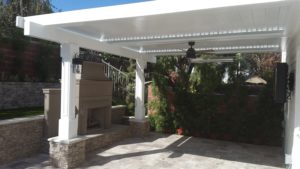 A louvered pergola covering a residential patio done by Apollo Opening Roof