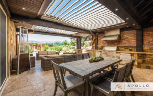 Apollo louvers integrated into custom exsisting structure over outdoor cooking, dining, and entertainment area.