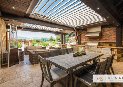 Apollo louvers integrated into custom exsisting structure over outdoor cooking, dining, and entertainment area.
