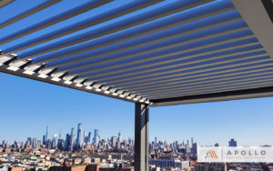 Slate and pewter louvered pergola installed on rooftop structure overlooking New Jersey Skyline.
