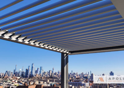 Slate and pewter louvered pergola installed on rooftop structure overlooking New Jersey Skyline.