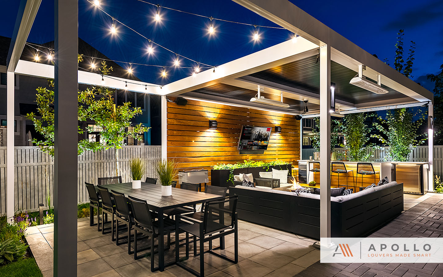 Contemporary motorized pergola w/ heaters, fans covers outdoor entertainment area w/ TV, fireplace, BBQ & seating.