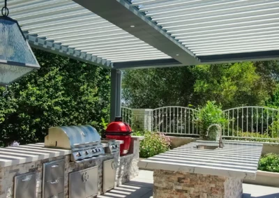 Louvered roof over outdoor kitchen. All weather solution to utilizing outdoor spaces year-round.