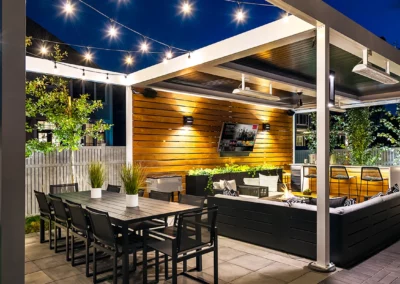 Luxurious louvered pergola creating a backyard oasis with entertainment area and ambient night lights