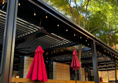 Louvered pergola with custom bronze framing at Back Bistro, Folsom, CA. Heaters, fans, and lights add ambiance.