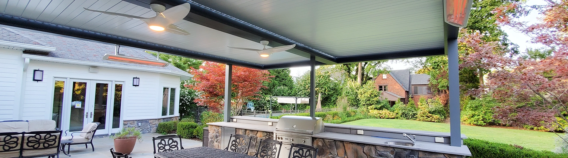 Louvered Patio Cover Over Modern Outdoor Cooking and Dining Area