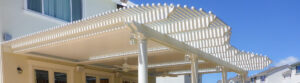 Luxury integrated louvered roof system with custom beams, corbels, and integrated amenities.