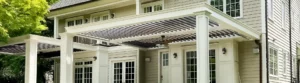Front view of wall-attached multi-bay aluminum pergolas to a multi-story home.