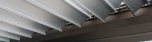 Close-up view of aluminum louvers installation on a patio roof.