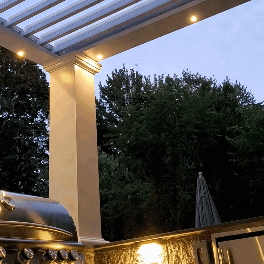 Louvered pergola slats open to a blue sky with white clouds with closed position below.