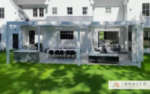 Apollo louvered pergola with smart shade system enhancing a stylish outdoor living space with dining and lounging areas.