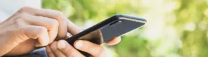 Person using a smartphone to control a smart pergola system, showcasing the ease of home automation.