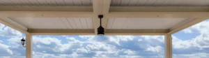 Close-up of a louvered roof pergola, capturing panoramic hill views.