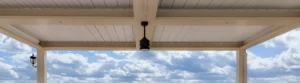Close-up of a louvered roof pergola, capturing panoramic hill views.