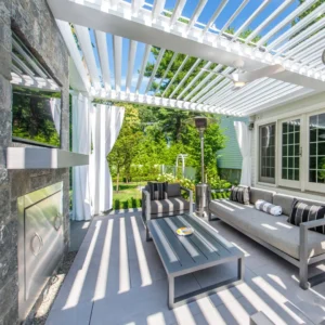 Outdoor patio with louvered pergola, modern furniture, fireplace, and heaters