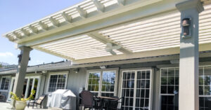 Backyard patio with louvered roof, ceiling fan, and outdoor furniture
