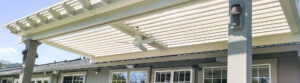 Louvered pergola roof with ceiling fan over backyard patio