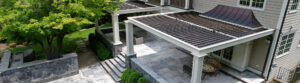Luxury louvered patio cover with stone flooring and outdoor seating