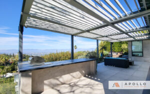 Outdoor patio with louvered pergola, built-in grill, and scenic city view