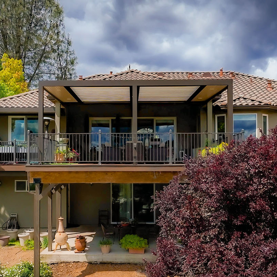 Two-story house with modern pergola-covered deck and landscaped yard