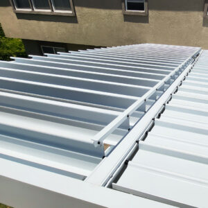 Close-up view of adjustable louvered patio roof blades and mechanism