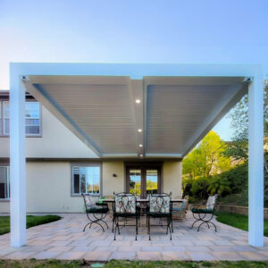 Backyard louvered patio cover with outdoor dining set beneath