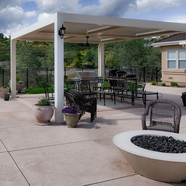 modern patio cover with firepit wicker chairs and outdoor BBQ setup