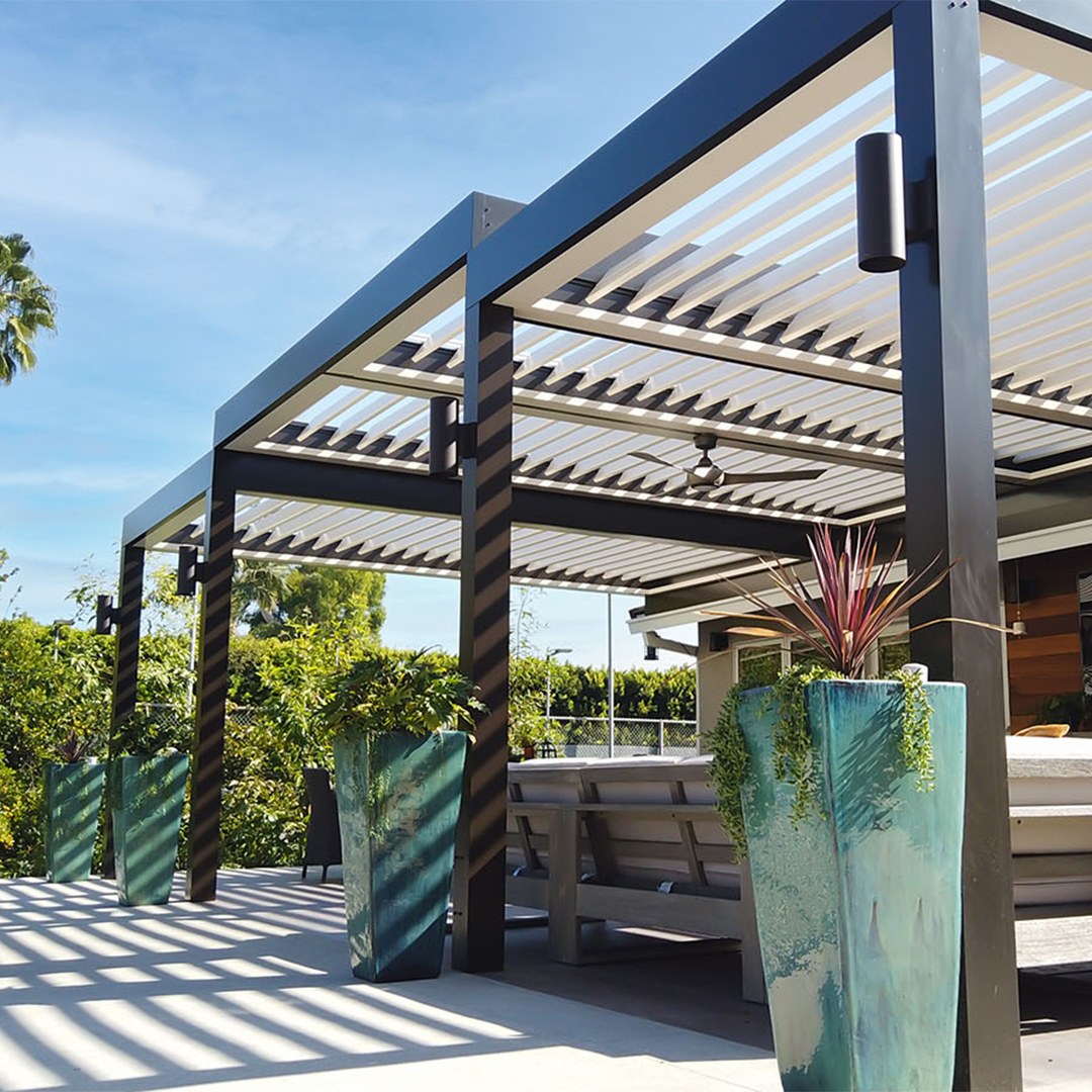 Louvered pergola with adjustable slats shading a modern outdoor lounge