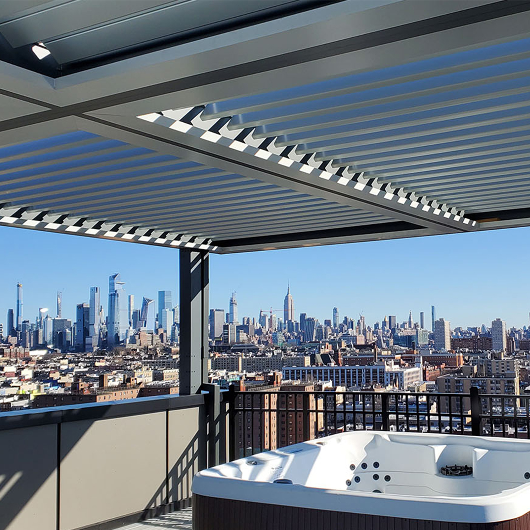 Louvered pergola shading a rooftop hot tub with city skyline views