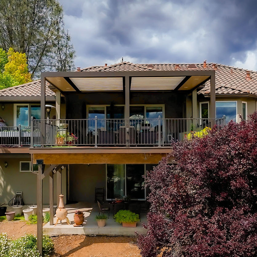 Louvered pergola covering an upper-level deck with outdoor seating