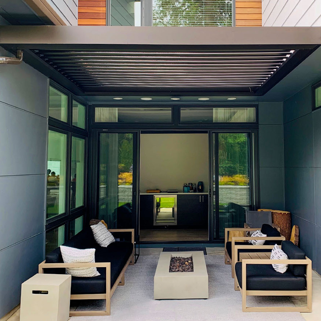 Modern pergola-covered patio with seating and a central fire table
