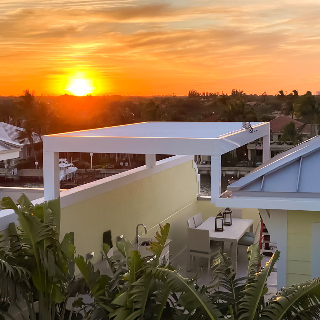 Rooftop pergola covering an outdoor dining area at sunset
