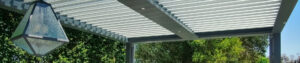 Panoramic view of freestanding louvered pergola with outdoor kitchen