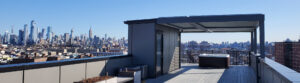 Rooftop pergola with hot tub overlooking a city skyline